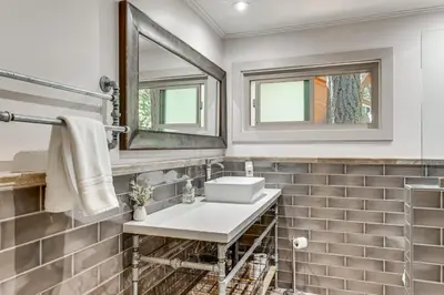 a bathroom with a sink and a mirror at Forest-View Haven with Game Room Tahoe City Gem! in Tahoe City