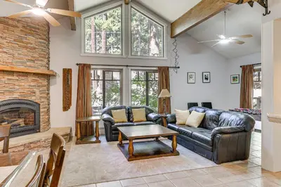 a living room with a couch and a fireplace at Forest-View Haven with Game Room Tahoe City Gem! in Tahoe City