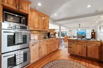 a kitchen with wooden cabinets and stainless steel appliances at Tallac View in Stateline