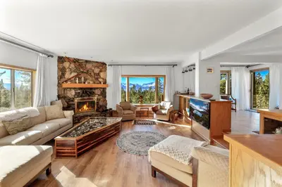 a living room with a couch and a fireplace at Tallac View in Stateline