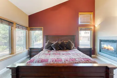 a bedroom with a large bed and a fireplace at Luxe All-Season Retreat by AvantStay Prime Location Near Skiing in Truckee
