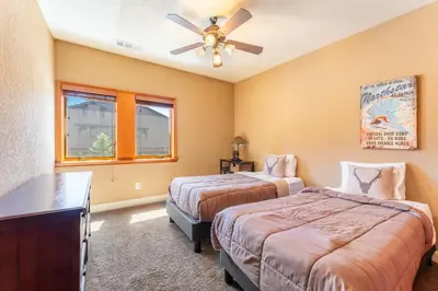 a bedroom with two beds and a ceiling fan at Luxe All-Season Retreat by AvantStay Prime Location Near Skiing in Truckee