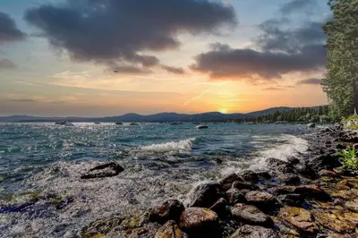 a sunset on the shore of a body of water at Lake Tahoe Vacation Rental w Patio & Pool Access in Kings Beach