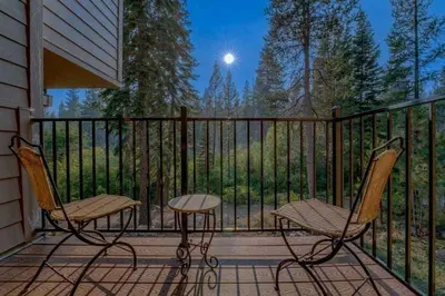 two chairs and a table on a porch with a fence at Carnelian Bay 3BR + Loft Near Beach & Trails in Carnelian Bay