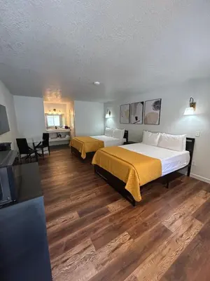 a hotel room with two beds and a television at Mi Wuk Village Inn in Mi-Wuk Village