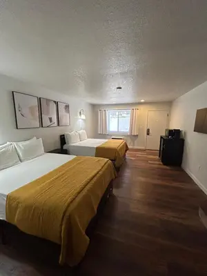 a hotel room with two beds and a window at Mi Wuk Village Inn in Mi-Wuk Village