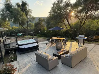 a patio with a table and chairs and a pool at Manzanita Hideaway Hot Tub Sunset views Yosemite in Ahwahnee