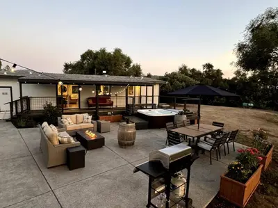 a patio with couches and a table and chairs at Manzanita Hideaway Hot Tub Sunset views Yosemite in Ahwahnee