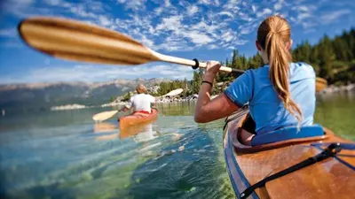 two people in kayaks on a body of water at Luxe 4 lake Tahoe Luxury With Hot Tub in Stateline