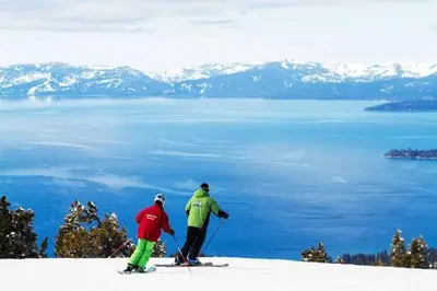 two people on skis on top of a snow covered mountain at Luxe 4 lake Tahoe Luxury With Hot Tub in Stateline