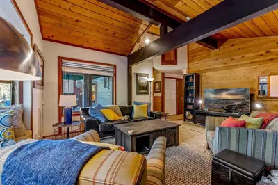 a living room with couches and a tv in a cabin at Secluded Tahoe Retreat Near Trails and Beach in Carnelian Bay