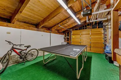 a ping pong table in a garage with a bike at Secluded Tahoe Retreat Near Trails and Beach in Carnelian Bay