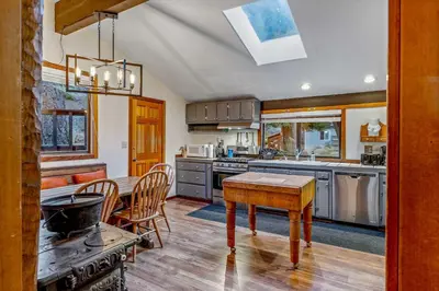 a kitchen with a table and a dining room at Secluded Tahoe Retreat Near Trails and Beach in Carnelian Bay