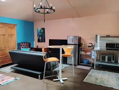 a living room with a couch and a table and chairs at Ping's Tiny Home self-check in & out private in Merced
