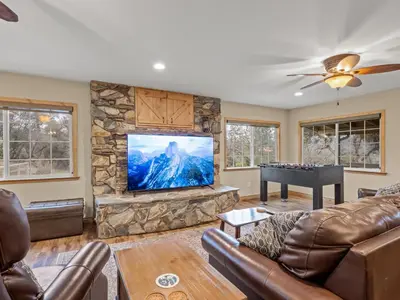 a living room with a flat screen tv and a piano at Manzanita Hill-35 miles to Yosemite, 10 miles to Mariposa with 8 person spa in Mariposa