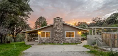 a home with a stone house with a patio at Manzanita Hill-35 miles to Yosemite, 10 miles to Mariposa with 8 person spa in Mariposa