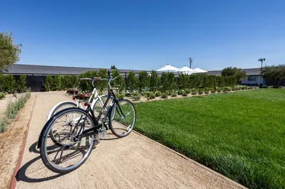 two bikes parked on a dirt path next to a field at Hotel Bayit in Modesto