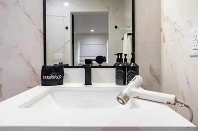 a bathroom with a sink and a mirror at Hotel Bayit in Modesto