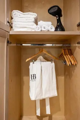 a closet with a shelf with towels on it at Hotel Bayit in Modesto