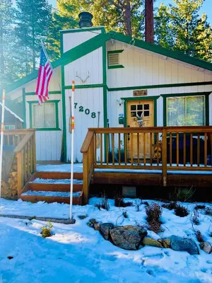 a house in the snow with an american flag at The Aspen House in Tahoma
