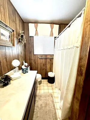 a bathroom with a toilet and a sink and a shower at The Aspen House in Tahoma
