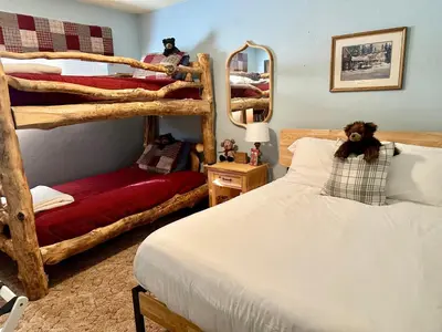 a bedroom with two bunk beds and a mirror at The Aspen House in Tahoma