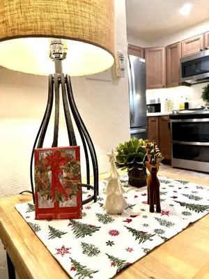 a table with a lamp and christmas decorations on it at The Aspen House in Tahoma