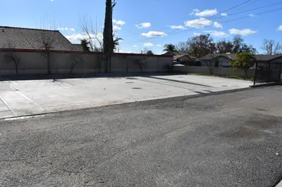 an empty street in front of a fence at Corcoran Inn in Corcoran