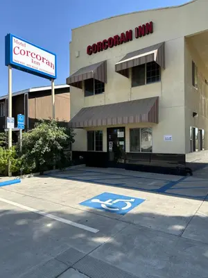 a parking lot in front of a hospital at Corcoran Inn in Corcoran