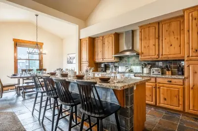 a kitchen with a large island with bar stools at Lodges 1156 in Mammoth Lakes