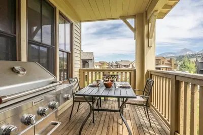 a balcony with a table and a grill and a table and chairs at Lodges 1156 in Mammoth Lakes