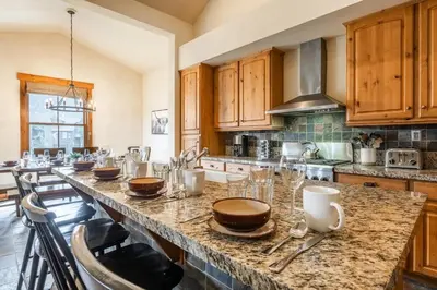 a kitchen with a large island with glasses on it at Lodges 1156 in Mammoth Lakes