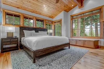 a bedroom with a large bed and windows at Northstar Hideaway-Private Hot Tub, Shuttle Access in Truckee