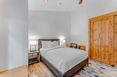 a bedroom with a bed and a wooden door at Northstar Hideaway-Private Hot Tub, Shuttle Access in Truckee