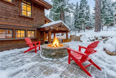 two red chairs and a fire pit in front of a house at Northstar Hideaway-Private Hot Tub, Shuttle Access in Truckee