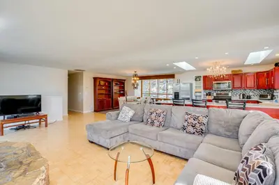 a large living room with a couch and a kitchen at Scenic Home with Sauna - 7 Mi to Heavenly Mountain! in Kingsbury