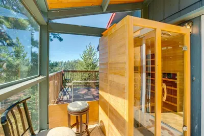 a tiny house with a large glass door on a deck at Scenic Home with Sauna - 7 Mi to Heavenly Mountain! in Kingsbury