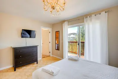 a bedroom with a bed and a television and a window at Scenic Home with Sauna - 7 Mi to Heavenly Mountain! in Kingsbury