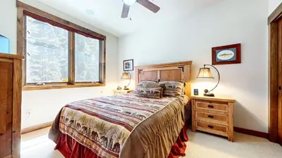 a bedroom with a bed and a window at Woodwinds #1303 condo in Mammoth Lakes