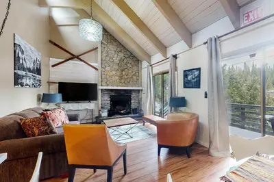 a living room with a couch and a fireplace at Snowy Pines in Fish Camp