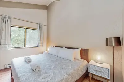 a bedroom with a bed and a large window at Snowy Pines in Fish Camp