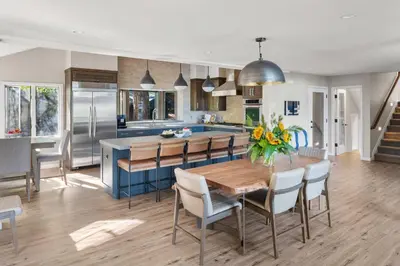 a kitchen and dining room with a wooden table and chairs at Luxury Tahoe Vacation Rental with HotTub & Lake Views in Tahoe Vista