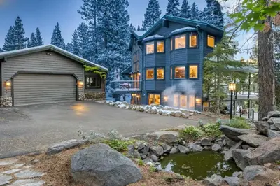 a large house with a garage and a driveway at Luxury Tahoe Vacation Rental with HotTub & Lake Views in Tahoe Vista