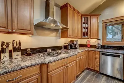 a kitchen with wooden cabinets and a stove top oven at On Tahoe Time - Pets Pool Table Game Room in South Lake Tahoe