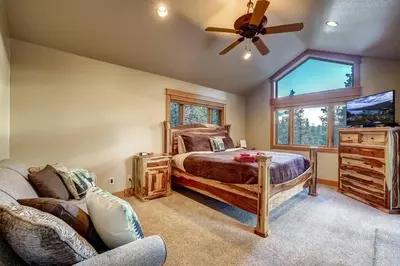 a bedroom with a bed and a ceiling fan at On Tahoe Time - Pets Pool Table Game Room in South Lake Tahoe