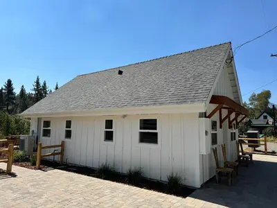 a white building with a gray roof at Ambrosia Hour on the Markleeville River in Markleeville