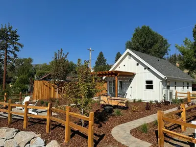 a white barn with wooden fences in a yard at Ambrosia Hour on the Markleeville River in Markleeville