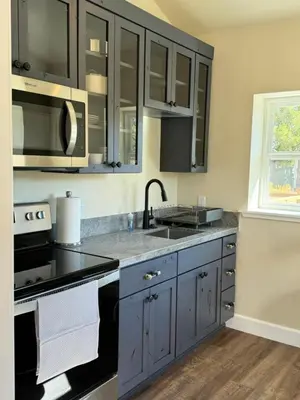a kitchen with gray cabinets and a sink at Ambrosia Hour on the Markleeville River in Markleeville