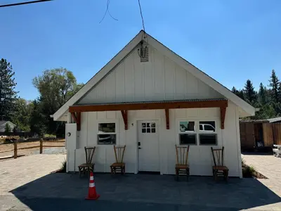a white garage with four chairs and a cone at Ambrosia Hour on the Markleeville River in Markleeville