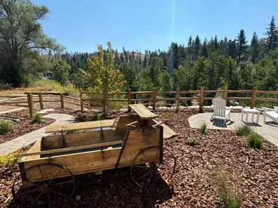 a wooden cart sitting in the middle of a garden at Ambrosia Hour on the Markleeville River in Markleeville